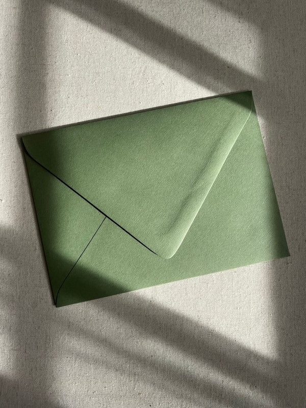 Small green paper envelope used for gift message cards