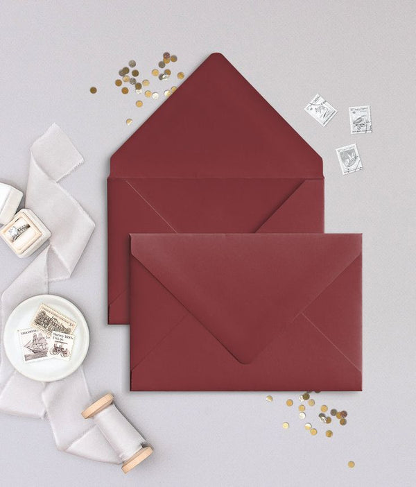 Small maroon paper envelope used for gift message cards